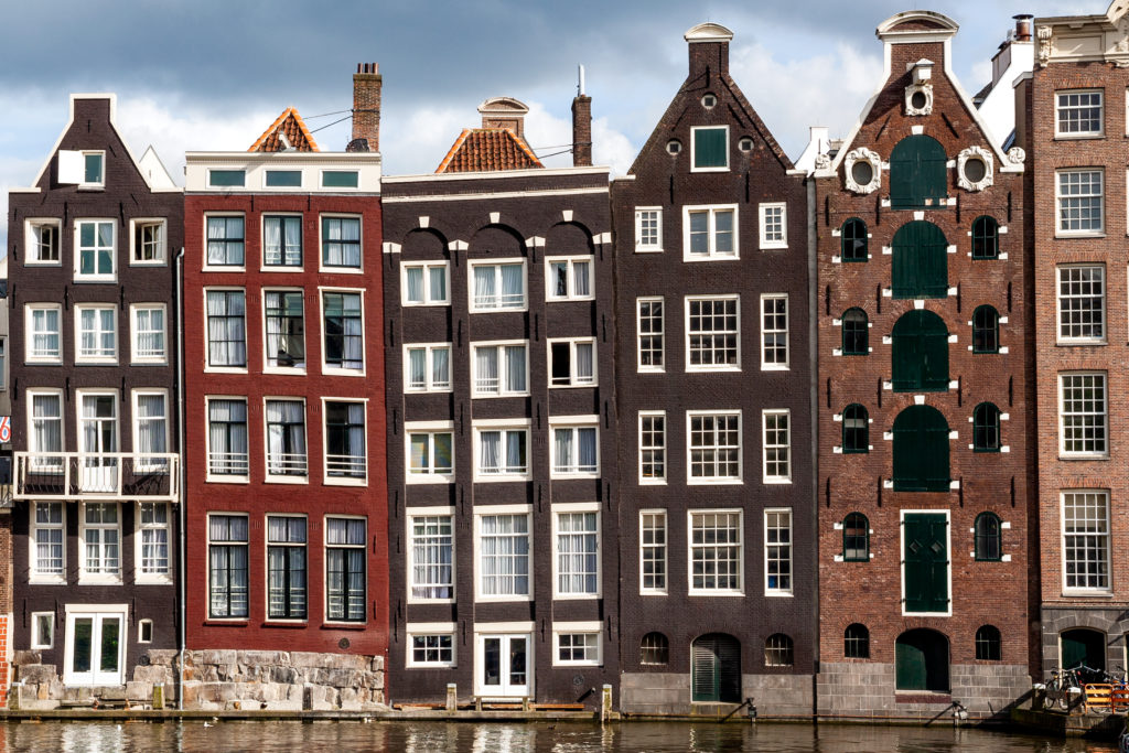 Row of gabled and old-fashioned narrow houses in Amsterdam.