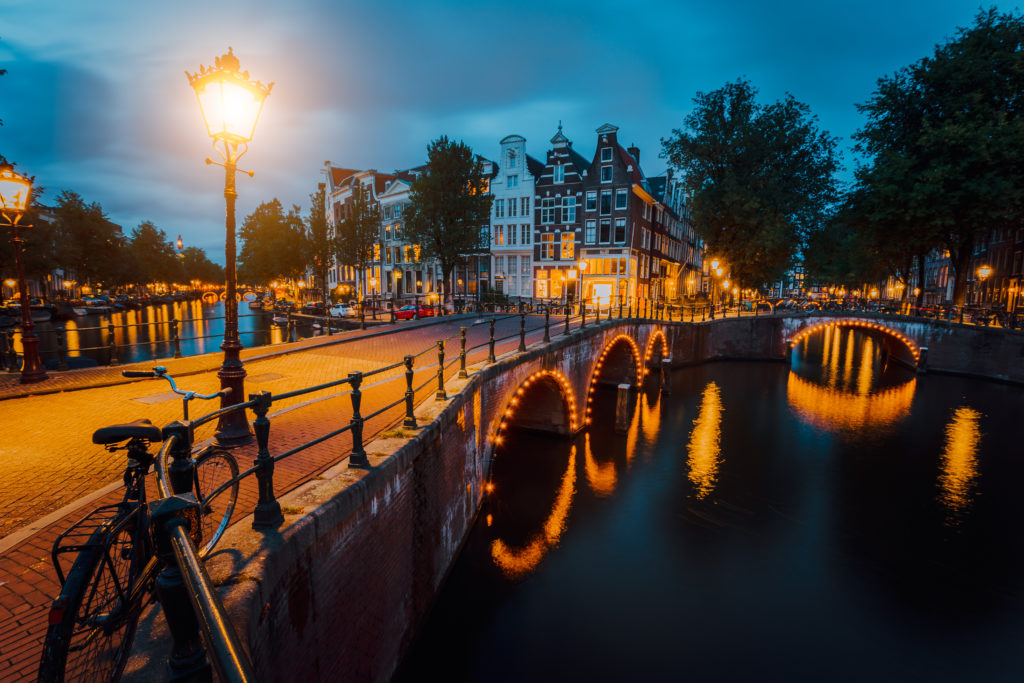 View of illuminated bridges in Amsterdam at night.