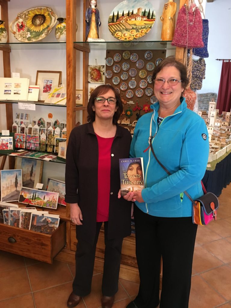 At San Gimignano 1300 with a copy of The Towers of Tuscany and the museum director