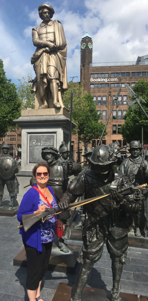 Posting with the statue of the Night Watch in the Rembrandtplein in Amsterdam