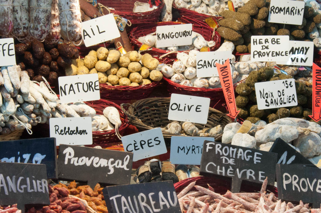 Selection of sausages in a French market - eat well on a budget in Europe by buying from markets