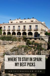 Pinterest graphic with the text where to stay in spain: my best picks below a picture of a fancy hotel iin Ronda, Spain with blue sky above.