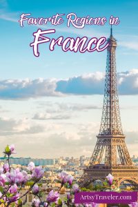 The Eiffel Tower viewed from a distance, framed by pink magnolia flowers, with the text "Favorite Regions in France" and "ArtsyTraveler.com" overlaid.