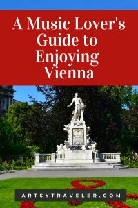 A statue of Wolfgang Amadeus Mozart on a white pedestal, surrounded by a garden with a treble clef design in red flowers. The image has a red overlay with white text reading, “A Music Lover’s Guide to Enjoying Vienna,” and the website "artsytraveler.com" below.