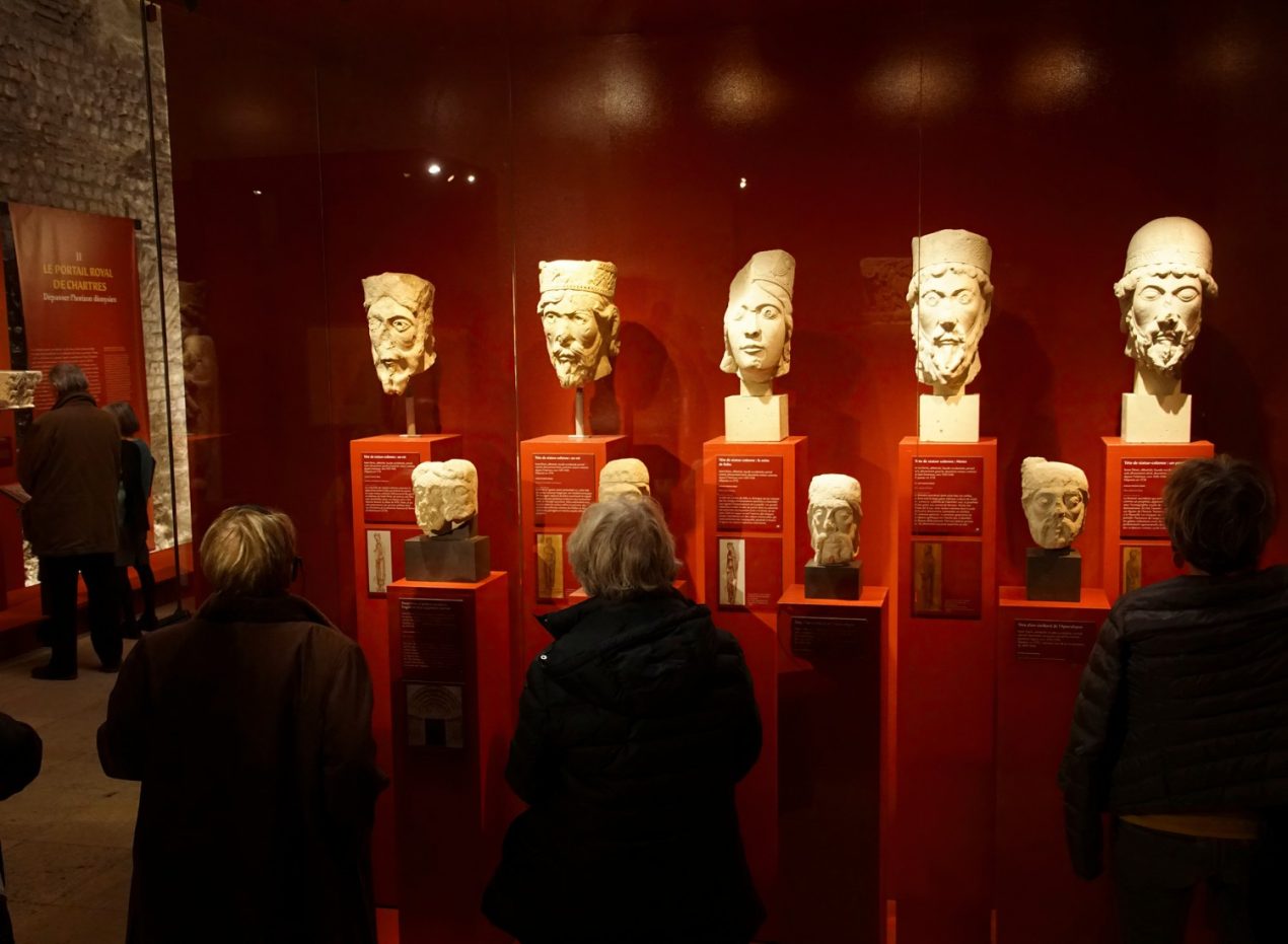 Row of sculptures in the Cluny Museum in Paris, one of the best small museums in Paris