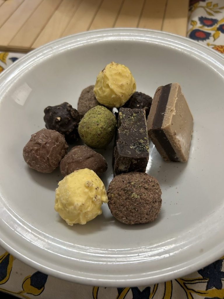 A plate of assorted chocolates and truffles, showcasing a delicious treat to enjoy while exploring Padua. Perfect for foodies visiting the city.