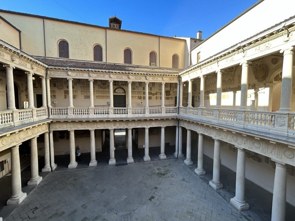 The grand courtyard of Palazzo Bo in Padua, featuring elegant arches and classical architecture. A significant historical site in the heart of Padua.