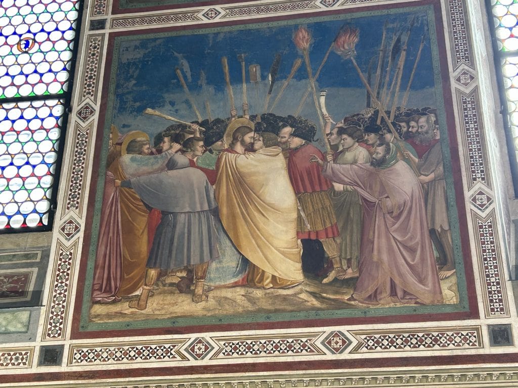 Giotto's depiction of the arrest of Christ, featuring dramatic expressions and intricate details in the Scrovegni Chapel. A highlight of Padua's artistic heritage.