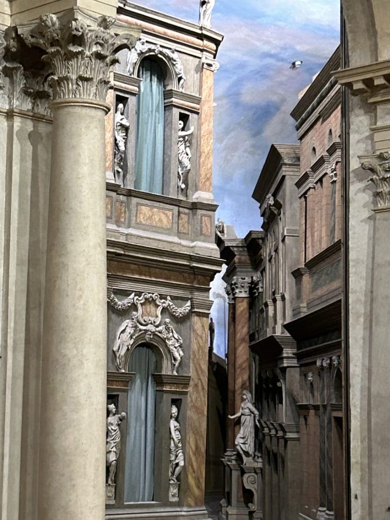 A detailed stage set in the Teatro Olimpico in Vicenza, featuring classical architectural elements. A must-see attraction near Padua for theater and history fans.