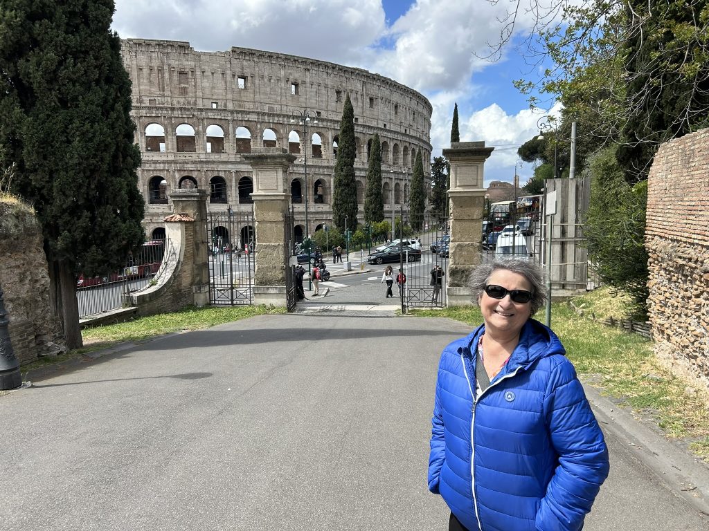 Carol Cram in front of the Colosseum in Rome