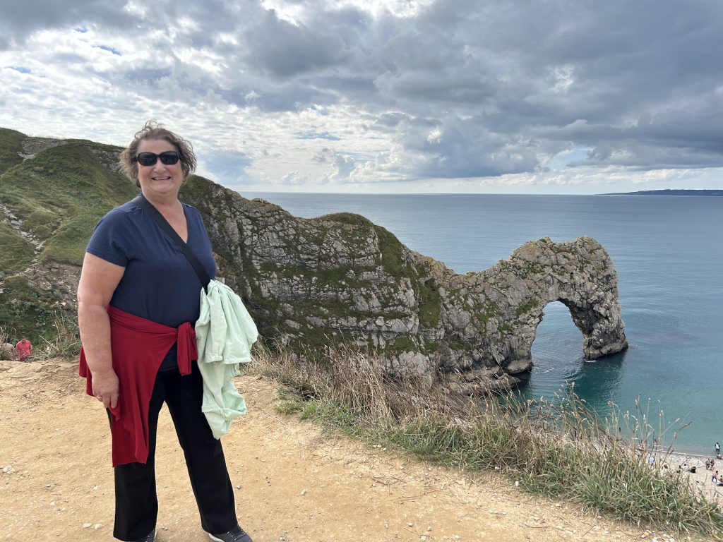 Carol Cram in front of Durdle Door on a Rabbie’s tour of southwest England