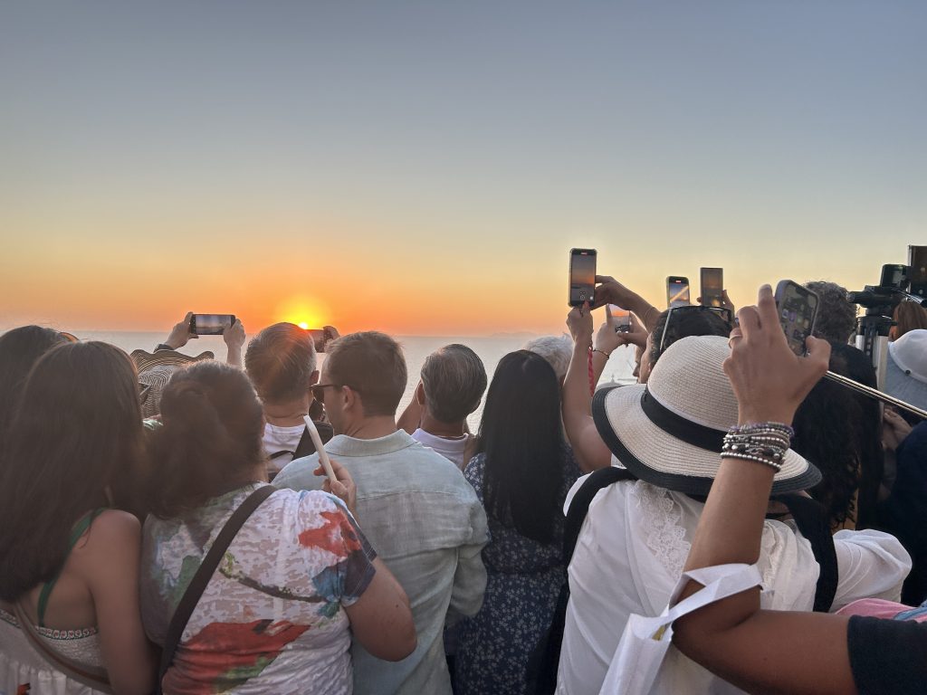 Crowds taking photos of the sunset on Santorini