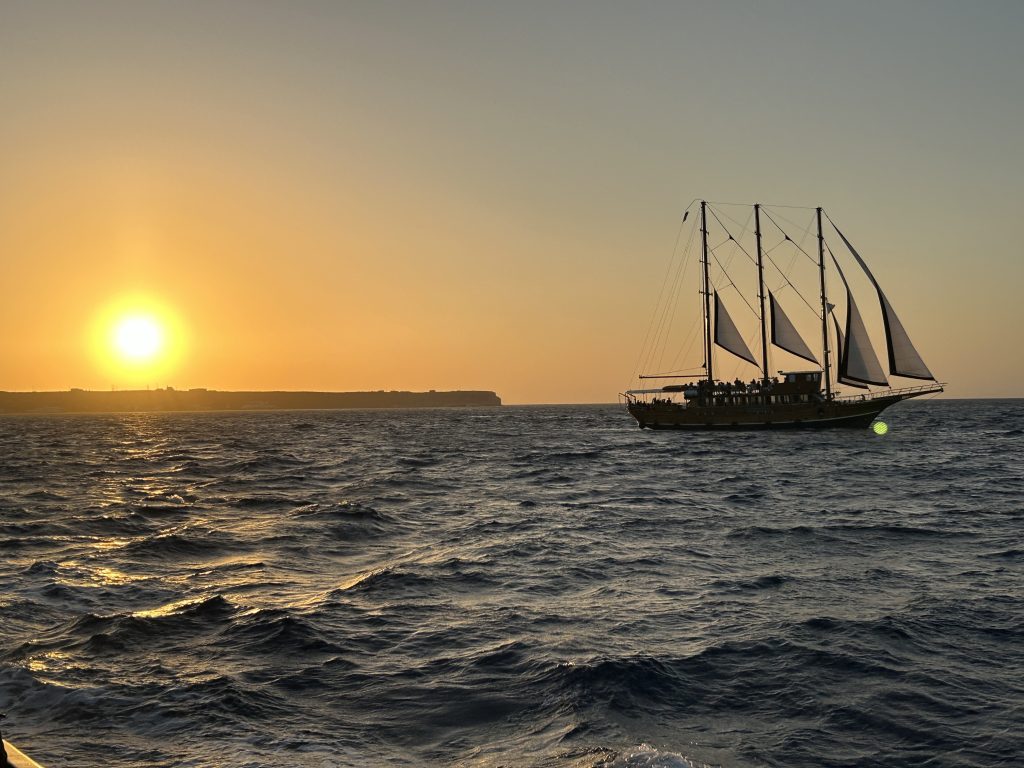 Sunset and boat in the caldera of Santorini