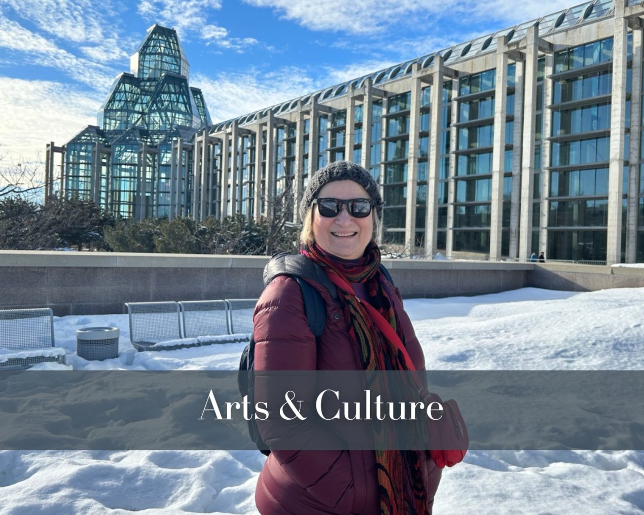 A woman wearing a red coat and black beanie stands in front of a modern glass building surrounded by snow. The overlay text reads "Arts & Culture."