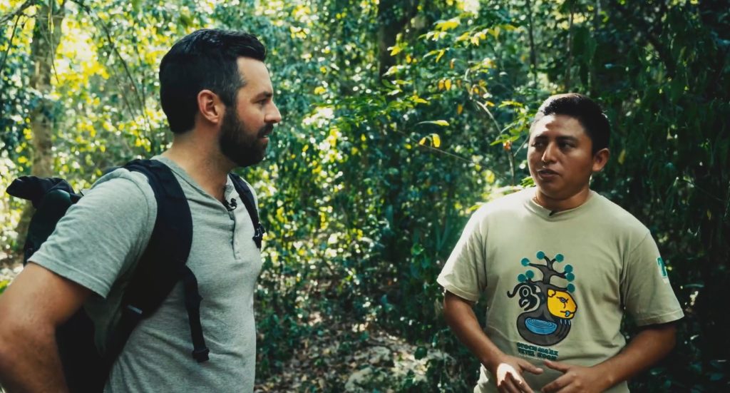 Documentary filmmaker Brady Skye to the left and Maya guide Rene Canul to the right with the jungle behind them in the Yucatan Peninsula in Meixco--a still from the documentary Beyound the Ruins.